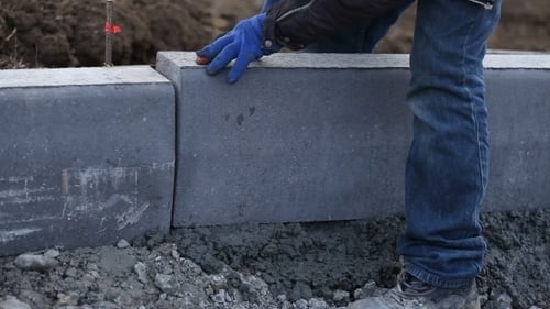 Worker Puts a Curb