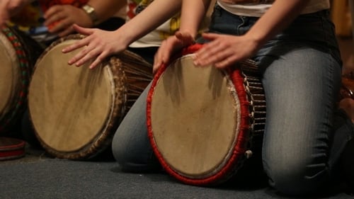 Group of Musicians Playing Djembe Drums