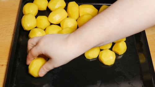 Putting Some Potatoes On A Baking Sheet