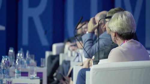 Adults at Corporate Event Sitting with Microphones