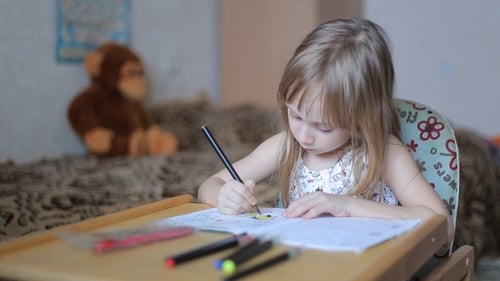Little Girl Drawing with Markers