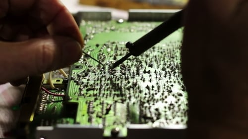 Hands Soldering Electronic Circuit Board Close Up