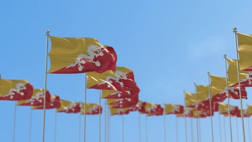 Bhutanese Flags Waving Under Clear Blue Sky