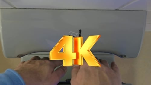 Person Using Automatic Hand Dryer in Restroom