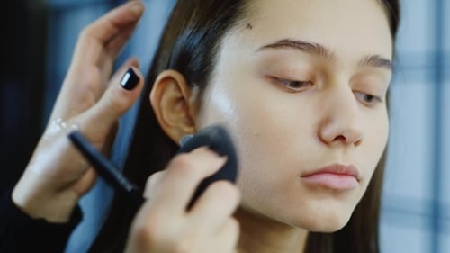 Woman Receiving Flawless Makeup Application Close Up