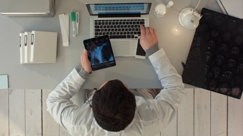 Man Using Tablet Pc Against Medical Xray. Top View
