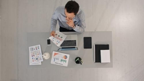 Top View Of Businessman Analyzing Financial Charts