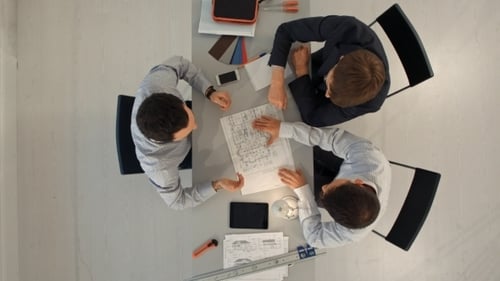 Architects In Office Looking At Construction