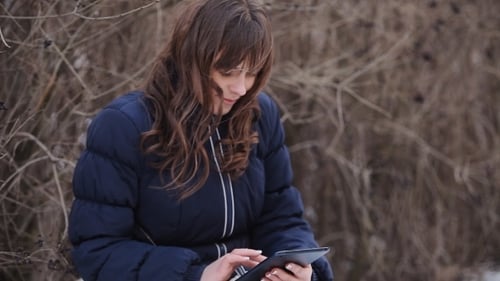 Woman On The Tablet Smartphone In Winter Park