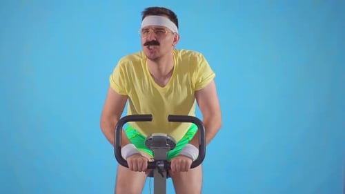 Man With Mustache Exercising on Stationary Bike