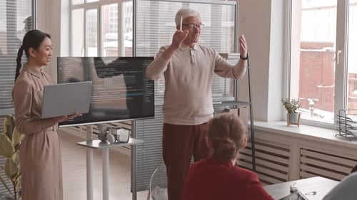 Emotional Senior Man Presenting Computer Code