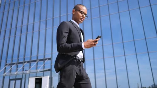 Young Businessman Talking On The Phone Working In The City