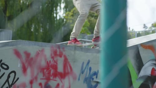 Young Adult Skateboarding on Ramp at Skatepark