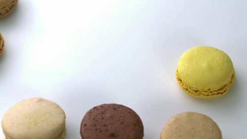 Colorful Macarons Arranged on White Surface