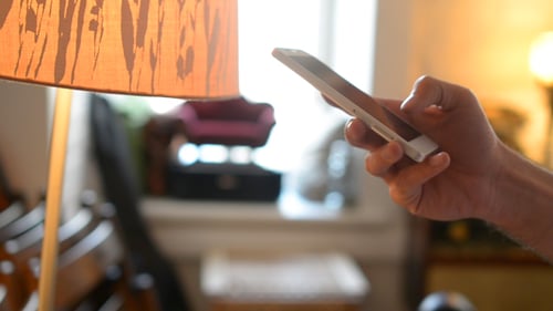 Hand Scrolls on Mobile Smartphone Indoors