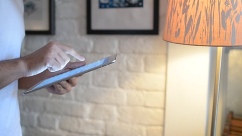 Adult Hands Using Tablet Indoors