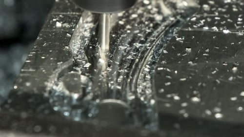 CNC Mill Cutting a Metal Part Close Up