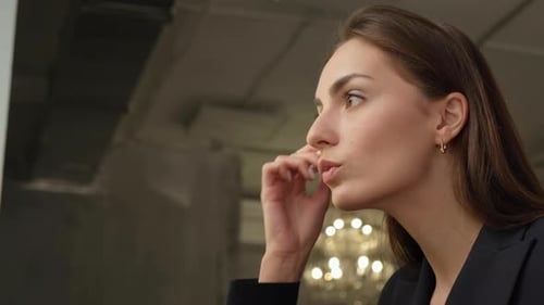 Young Woman Applying Powder Foundation with Brush