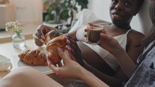 Women Enjoying Breakfast Together in Bed