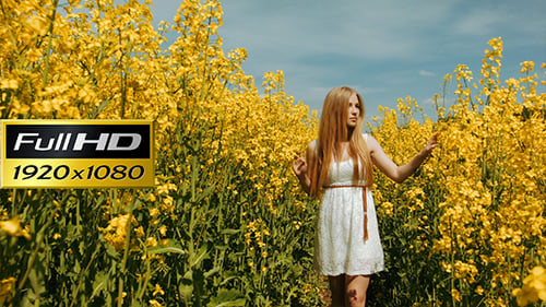 Young Girl Walking Through The Tall Grass