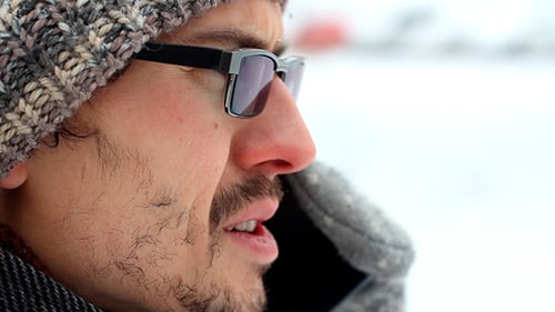 Man Talking On The Phone Outdoors In Winter