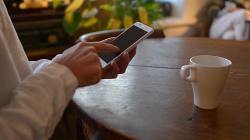 Casual Man Using Smartphone on Table