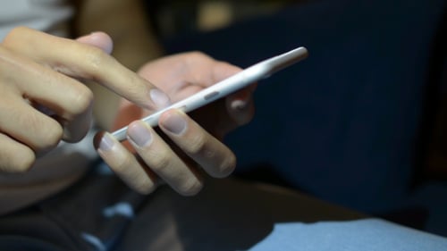 Hand Using Smartphone Close Up Indoors