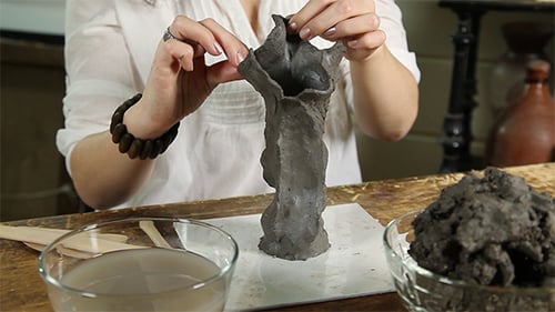 Woman Sculpting Grey Clay Sculpture with Hand Tools