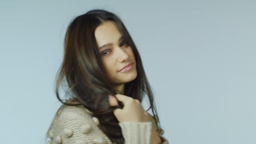 Young Woman Stroking Her Beautiful Hair