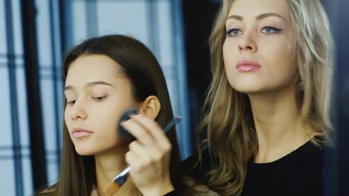 Makeup Artist Applies Foundation in Beauty Studio