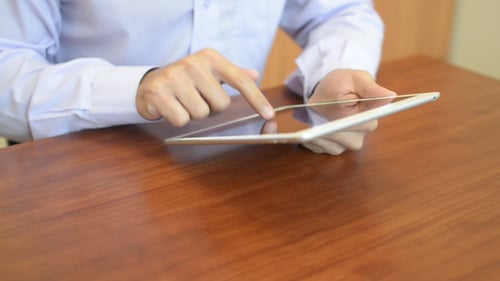 Man Using Tablet Device at Work