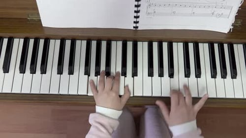 Child playing piano. Close up