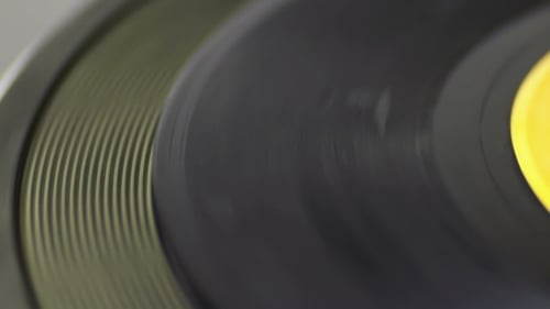 Dark Vinyl Record Rotating on Turntable Close Up