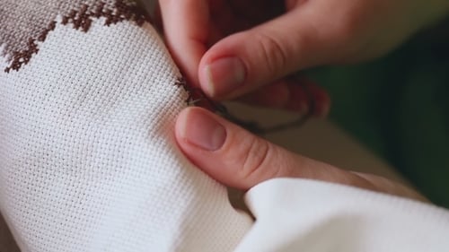 Close Up of Hands Cross Stitching