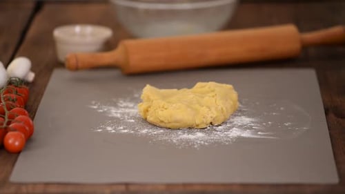 The Dough Rolling the Women's Hands.