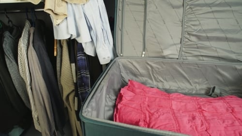Clothes are packed in suitcase for travel
