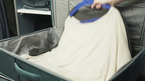 Packing Clothes in Luggage for Trip, Ready to Travel