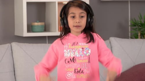 Energetic Girl Dancing with Headphones in Living Room