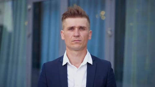 Serious Adult Man Standing in Front of Building