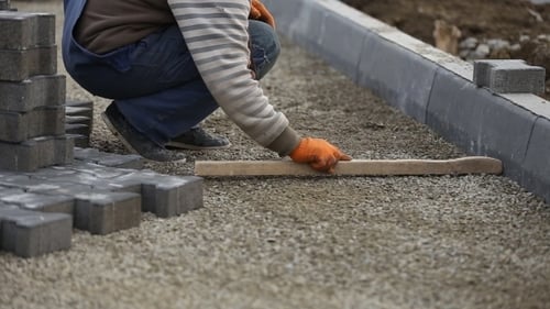 Leveling Gravel a Wooden Board