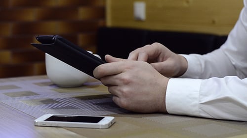 Man Typing On The Tablet