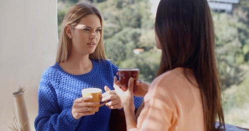 Young Women Chatting and Drinking Coffee