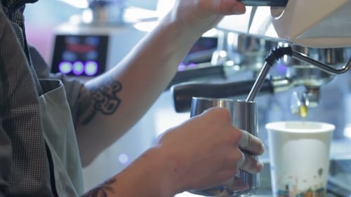 Young Adult Making Coffee With Espresso Machine