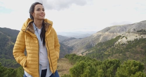Woman Admiring Mountainous Scenery in Green Valley