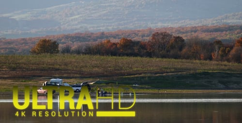 Family Camping by Calm Lake in Rural Setting