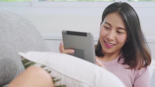 Woman Using Tablet and Drinking Coffee at Home