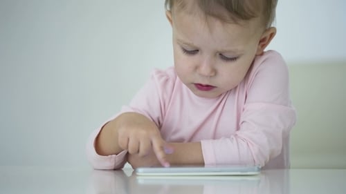 Cute Infant Uses Touch Screen Tablet