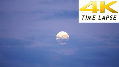 Full Moon Moving Behind the Clouds at Night