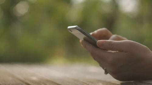 Woman Using Smartphone Outdoors Close Up