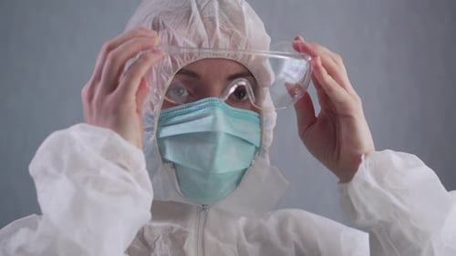 Medical Professional Puts on Protective Eyewear